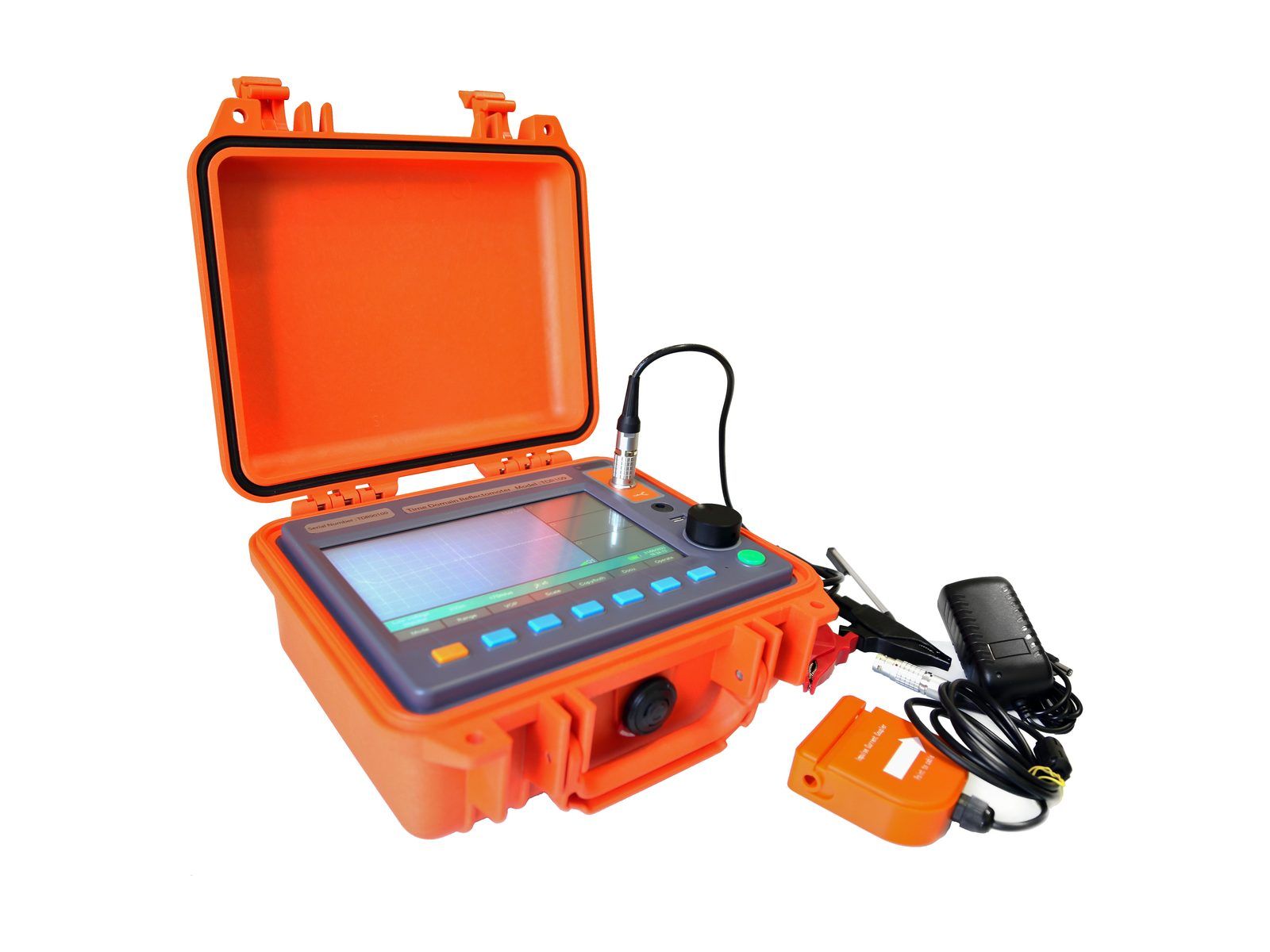 The TDR-901 kit laid out: the reflectometer in its open orange case with test leads, a mains adapter and a coupler.